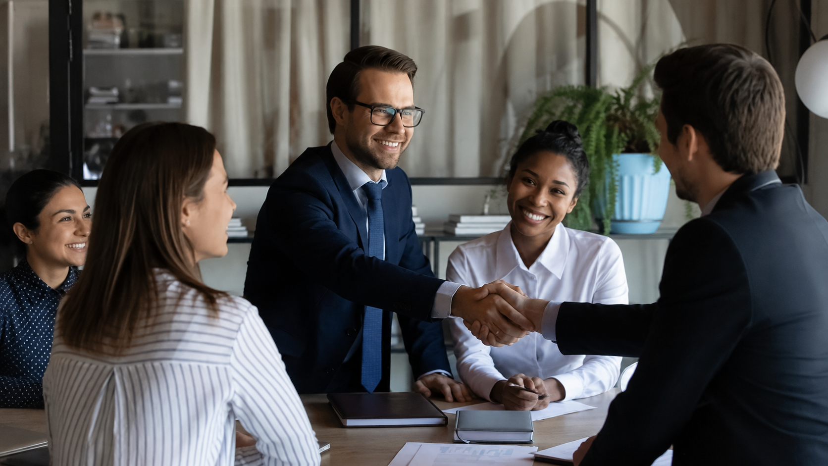 Professional investors and partners shaking hands during a meeting